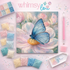 Diy art kit with blue butterfly on a flower, surrounded by colorful beads and tools, branded 'whimsy lou'.